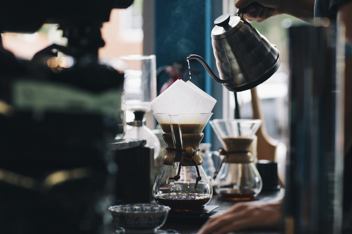 Black and white editorial photo of a slow pour-over brew at the Bruma roastery